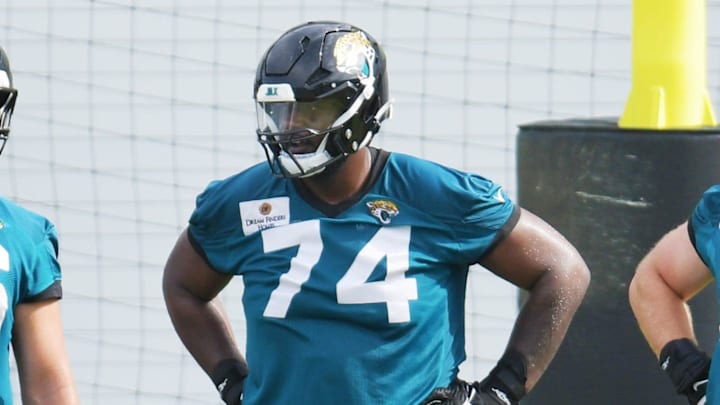 Jacksonville Jaguars guard Ezra Cleveland (76) with offensive tackle Cam Robinson (74) and offensive tackle Walker Little (72) during a break between drills during the second day of an NFL football training camp practice session Thursday, July 25, 2024 at EverBank StadiumÕs Miller Electric Center in Jacksonville, Fla. [Bob Self/Florida Times-Union]