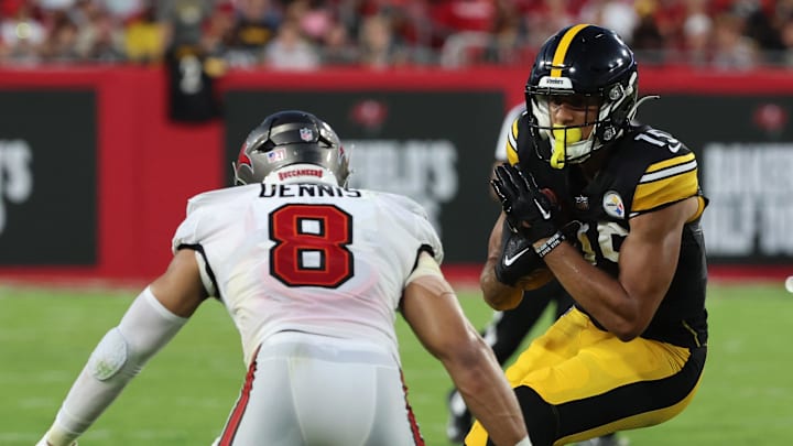 Pittsburgh Steelers wide receiver Cody White runs with the ball as Tampa Bay Buccaneers linebacker SirVocea Dennis (8) defends.