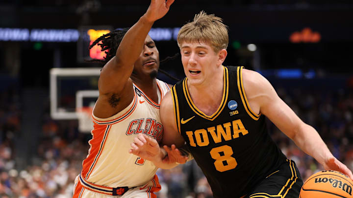 Mar 20, 2026; Tampa, FL, USA; Iowa Hawkeyes forward Cooper Koch (8) drives the ball while defended by Clemson Tigers guard Jestin Porter (1) in the second half during a first round game of the men's 2026 NCAA Tournament at Benchmark International Arena. Mandatory Credit: Matt Pendleton-Imagn Images Mar 20, 2026; Tampa, FL, USA; Iowa Hawkeyes forward Cooper Koch (8) drives the ball while defended by Clemson Tigers guard Jestin Porter (1) in the second half during a first round game of the men's 2026 NCAA Tournament at Benchmark International Arena. Mandatory Credit: Matt Pendleton-Imagn Images
