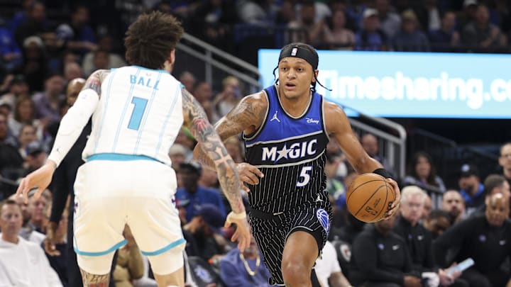 Jan 22, 2026; Orlando, Florida, USA; Orlando Magic forward Paolo Banchero (5) moves the ball past Charlotte Hornets guard LaMelo Ball (1) in the first quarter at Kia Center. Mandatory Credit: Nathan Ray Seebeck-Imagn Images Jan 22, 2026; Orlando, Florida, USA; Orlando Magic forward Paolo Banchero (5) moves the ball past Charlotte Hornets guard LaMelo Ball (1) in the first quarter at Kia Center. Mandatory Credit: Nathan Ray Seebeck-Imagn Images