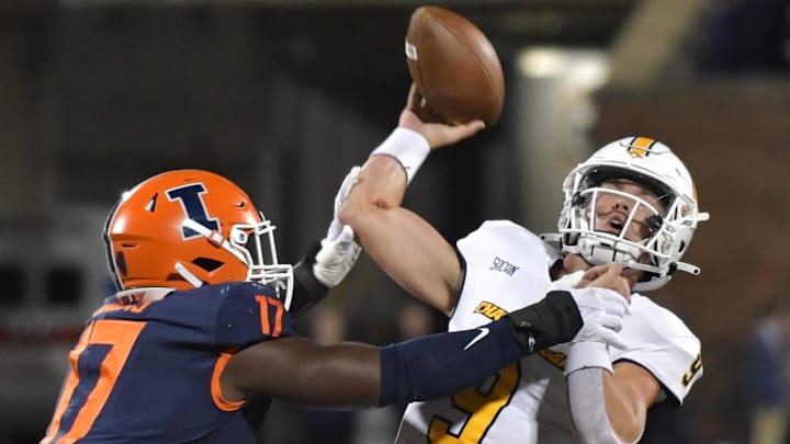 Sep 22, 2022; Champaign, Illinois, USA; Illinois Fighting Illini linebacker Gabe Jacas (17) tackles Chattanooga Mocs quarterback Preston Hutchinson (9) as he passes the ball during the first half at Memorial Stadium. Mandatory Credit: Ron Johnson-Imagn Images