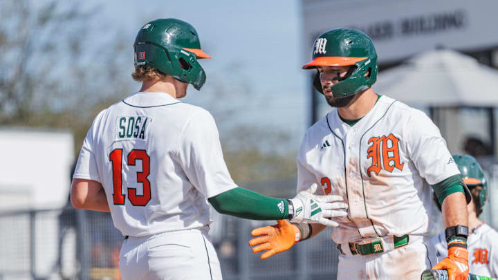 Miami Hurricanes catcher Alex Sosa (13) and right fielder Derek Williams (2) against Lafayette 