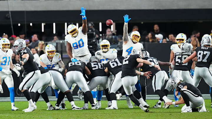 Jan 5, 2025; Paradise, Nevada, USA; Las Vegas Raiders place kicker Daniel Carlson (2) kicks a field goal as Los Angeles Chargers defensive tackle Teair Tart (90) and Los Angeles Chargers defensive tackle Scott Matlock (44) look to block the attempt during the fourth quarter at Allegiant Stadium. Mandatory Credit: Stephen R. Sylvanie-Imagn Images