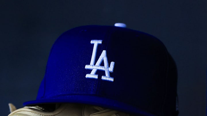 Jul 30, 2025; Cincinnati, Ohio, USA; A general view of a Los Angeles Dodgers hat and glove during the second inning in the game against the Cincinnati Reds at Great American Ball Park. Jul 30, 2025; Cincinnati, Ohio, USA; A general view of a Los Angeles Dodgers hat and glove during the second inning in the game against the Cincinnati Reds at Great American Ball Park.