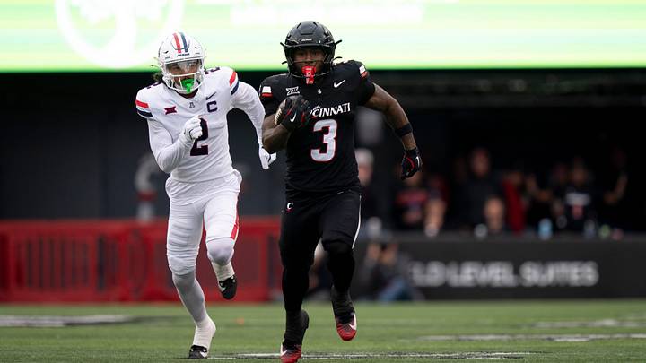 Cincinnati Bearcats running back Tawee Walker (3) runs for 54-yards as Arizona Wildcats defensive back Treydan Stukes (2) chases in the first quarter of the NCAA football game between the Cincinnati Bearcats and Arizona Wildcats at Nippert Stadium in Cincinnati on Nov. 15, 2025.