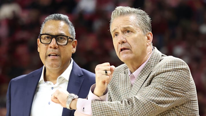Nov 13, 2024; Fayetteville, Arkansas, USA; Arkansas Razorbacks assistant coach Chuck Martin looks on as head coach John Calipari reacts to a non call in the second half against the Troy Trojans at Bud Walton Arena. Arkansas won 65-49. Mandatory Credit: Nelson Chenault-Imagn Images