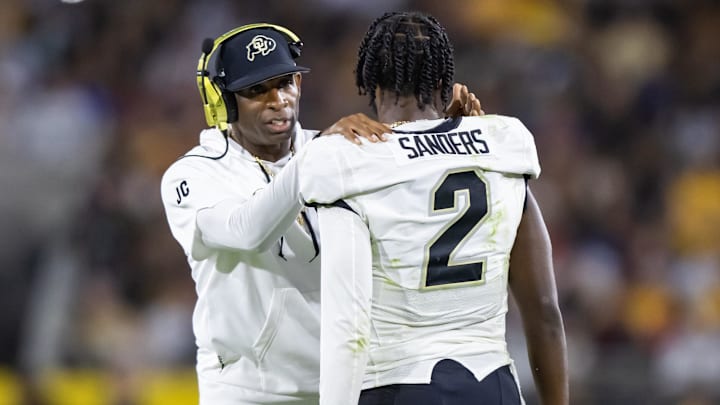 Oct 7, 2023; Tempe, Arizona, USA; Colorado Buffaloes head coach Deion Sanders with son and quarterback Shedeur Sanders (2) against the Arizona State Sun Devils at Mountain America Stadium. Mandatory Credit: Mark J. Rebilas-Imagn Images
