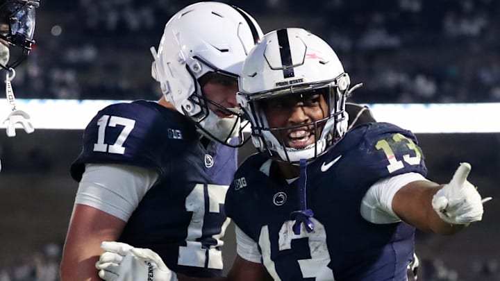 Nov 22, 2025; University Park, Pennsylvania, USA; Penn State Nittany Lions running back Kaytron Allen (13) celebrates with quarterback Ethan Grunkemeyer (17) after scoring a touchdown during the fourth quarter against the Nebraska Cornhuskers at Beaver Stadium. Mandatory Credit: Matthew O'Haren-Imagn Images