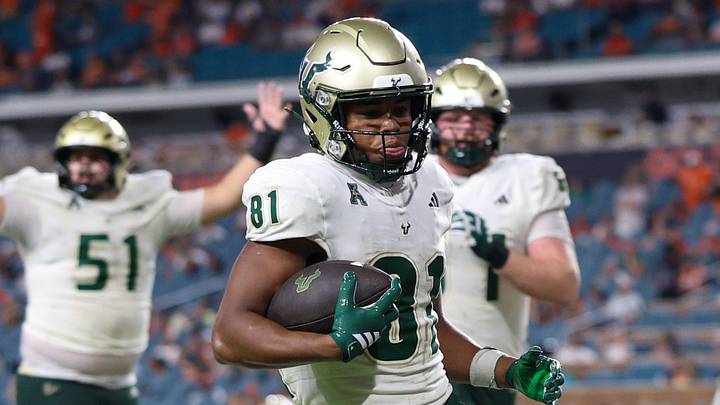 Sep 13, 2025; Miami Gardens, Florida, USA; South Florida Bulls wide receiver Christian Neptune (81) runs for a touchdown against the Miami Hurricanes in the fourth quarter at Hard Rock Stadium. Mandatory Credit: Nathan Ray Seebeck-Imagn Images