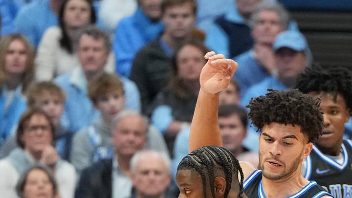 Feb 7, 2026; Chapel Hill, North Carolina, USA; North Carolina Tar Heels forward Caleb Wilson (8) with the ball as Duke Blue Devils forward Cameron Boozer (12) defends in the first half at Dean E. Smith Center. Mandatory Credit: Bob Donnan-Imagn Images