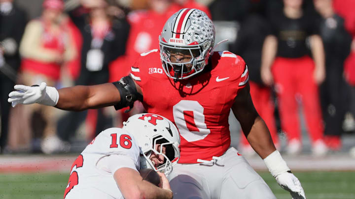 Ohio State Buckeyes linebacker Sonny Styles tackles Rutgers Scarlet Knights quarterback Athan Kaliakmanis 