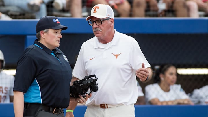 Texas Longhorns head coach Mike White talks to the home plate umpire in the first inning against the Texas Tech Red Raiders.