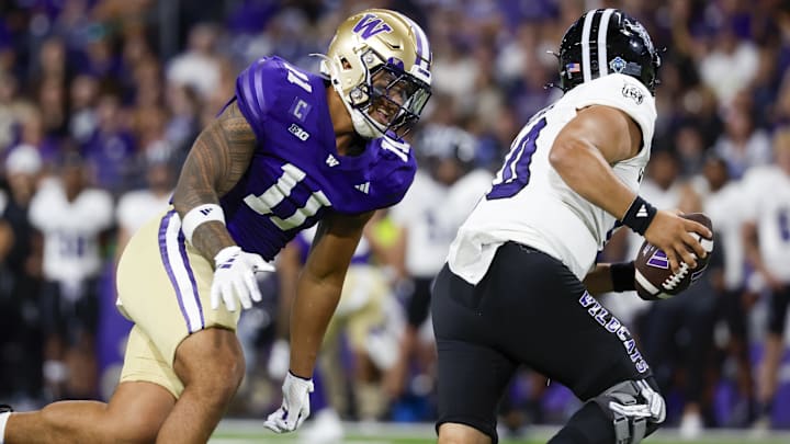 Aug 31, 2024; Seattle, Washington, USA; Washington Huskies linebacker Alphonzo Tuputala (11) pressures Weber State Wildcats quarterback Richie Munoz (10) during the third quarter at Alaska Airlines Field at Husky Stadium.
