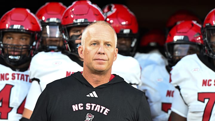Sep 11, 2025; Winston-Salem, North Carolina, USA; North Carolina State Wolfpack head coach Dave Doeren walks his team out on the field against the Wake Forest Demon Deacons at Allegacy Federal Credit Union Stadium. Mandatory Credit: Luke Jamroz-Imagn Images Sep 11, 2025; Winston-Salem, North Carolina, USA; North Carolina State Wolfpack head coach Dave Doeren walks his team out on the field against the Wake Forest Demon Deacons at Allegacy Federal Credit Union Stadium. Mandatory Credit: Luke Jamroz-Imagn Images