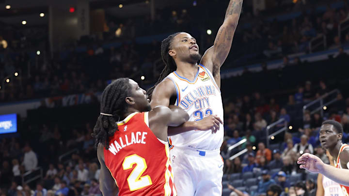 Oct 17, 2024; Oklahoma City, Oklahoma, USA; Oklahoma City Thunder guard Cason Wallace (22) shoots over Atlanta Hawks guard Keaton Wallace (2) during the second half at Paycom Center. Mandatory Credit: Alonzo Adams-Imagn Images