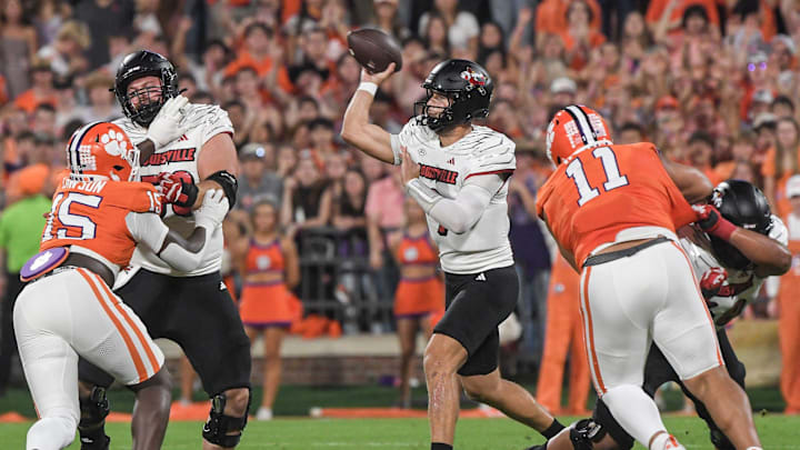 Nov 2, 2024; Clemson, South Carolina, USA; Louisville Cardinals quarterback Tyler Shough (9) throws against Clemson Tigers defensive end Jahiem Lawson (15) and defensive lineman Peter Woods (11) during the first quarter at Memorial Stadium. Nov 2, 2024; Clemson, South Carolina, USA; Louisville Cardinals quarterback Tyler Shough (9) throws against Clemson Tigers defensive end Jahiem Lawson (15) and defensive lineman Peter Woods (11) during the first quarter at Memorial Stadium.