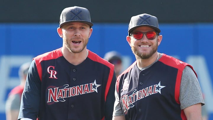 National League infielders Trevor Story (left) of the Colorado Rockies and Max Muncy (right) of the Los Angeles Dodgers react during warm-ups before the 2019 MLB All Star Game at Progressive Field on July 9, 2019.