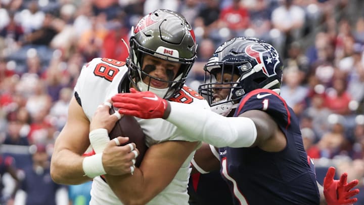 Nov 5, 2023; Houston, Texas, USA; Tampa Bay Buccaneers tight end Cade Otton (88) is tackled by Houston Texans safety Jimmie Ward (1) in the first quarter  at NRG Stadium. Mandatory Credit: Thomas Shea-Imagn Images