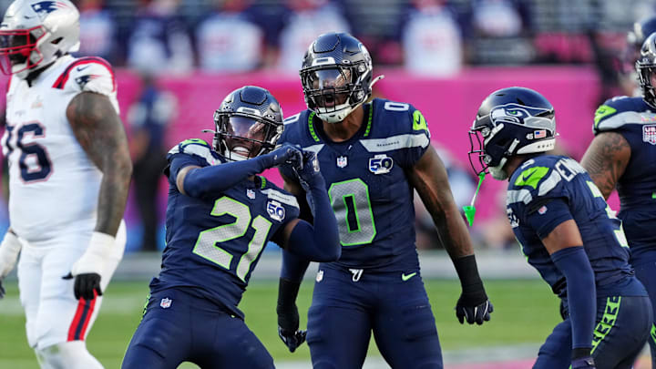Feb 8, 2026; Santa Clara, CA, USA; Seattle Seahawks defensive end DeMarcus Lawrence (0) and Seattle Seahawks cornerback Devon Witherspoon (21) react after a play during the first quarter against the New England Patriots in Super Bowl LX at Levi's Stadium.