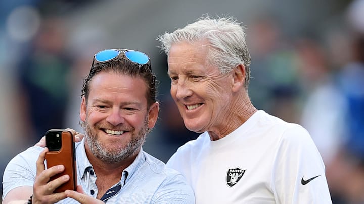 John Schneider and former Seattle Seahawks coach Pete Carroll smile