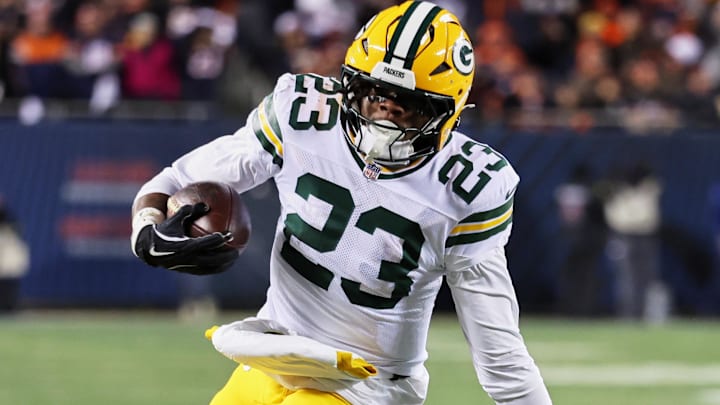 Green Bay Packers running back Emanuel Wilson runs with the ball against Chicago Bears cornerback Tyrique Stevenson.