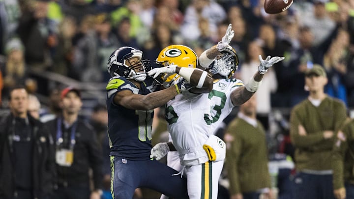 Nov 15, 2018; Seattle, WA, USA; Seattle Seahawks wide receiver Tyler Lockett (16) draws a pass interference call on Green Bay Packers cornerback Jaire Alexander (23) and Green Bay Packers defensive back Raven Greene (36) during the first half at CenturyLink Field. Seattle defeated Green Bay 27-24. Mandatory Credit: Steven Bisig-Imagn Images