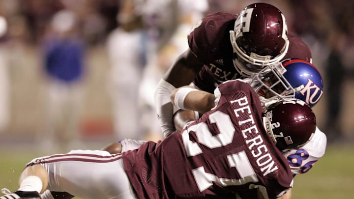 Oct 27, 2007; College Station, TX, USA; Kansas Jayhawks wide receiver Marcus Henry (86) is tackled by Texas A&M Aggies defensive back Jordan Peterson (27) and defensive back Alton Dixon (9) in the third quarter at Kyle Field. Kansas beat Texas A&M 19-11. Mandatory Credit: Brett Davis-Imagn Images Oct 27, 2007; College Station, TX, USA; Kansas Jayhawks wide receiver Marcus Henry (86) is tackled by Texas A&M Aggies defensive back Jordan Peterson (27) and defensive back Alton Dixon (9) in the third quarter at Kyle Field. Kansas beat Texas A&M 19-11. Mandatory Credit: Brett Davis-Imagn Images