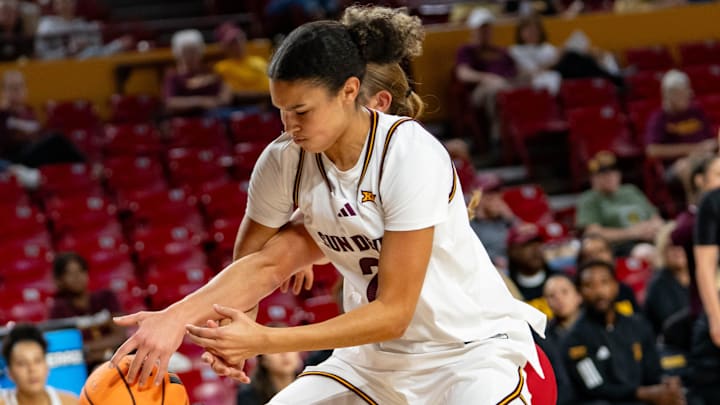 Arizona State Sun Devils McKinna Brackens (21) and Eastern Washington Eagles Emily McElmurry (23) fight for possession during a game at Desert Financial Arena in Tempe, on Nov. 8, 2025.