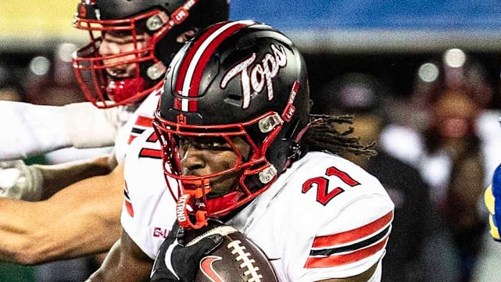 Western Kentucky running back Marvis Parrish (21) runs the ball, with offensive lineman Quincy Jenkins (63) providing cover, against Delaware Blue Hens linebacker Blake Matthews (10) during Delaware's first home CUSA football game, which was nationally televised, at Delaware Stadium in Newark on Oct. 3, 2025. Western Kentucky won 27-24.