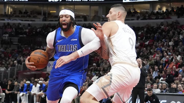 Mar 29, 2025; Chicago, Illinois, USA; Chicago Bulls center Nikola Vucevic (9) defends Dallas Mavericks forward Anthony Davis (3) during the second half at United Center. Mandatory Credit: David Banks-Imagn Images
