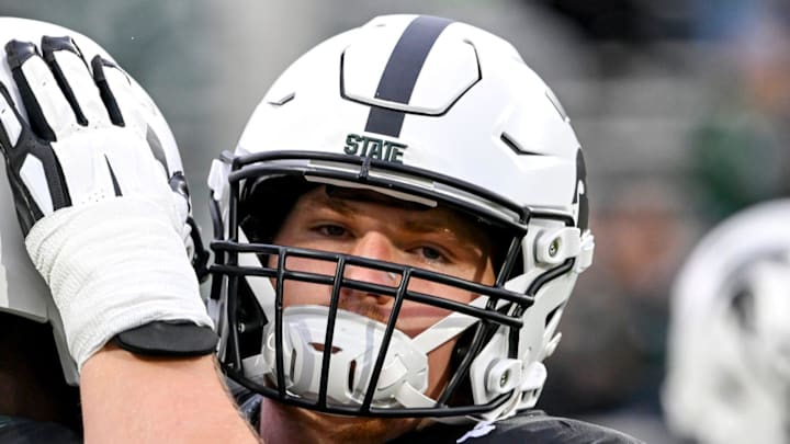Michigan State's Matt Gulbin, right, hugs quarterback Aidan Chiles before the football game against Boston College on Saturday, Sept. 6, 2025, at Spartan Stadium in East Lansing.