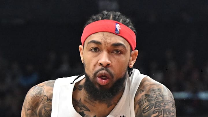 Toronto Raptors forward Brandon Ingram fouls Portland Trail Blazers forward Sidy Cissoko.