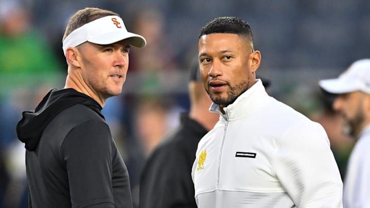 Oct 14, 2023; South Bend, Indiana, USA; USC Trojans head coach Lincoln Riley and Notre Dame Fighting Irish head coach Marcus Freeman chat before the game at Notre Dame Stadium. Mandatory Credit: Matt Cashore-Imagn Images