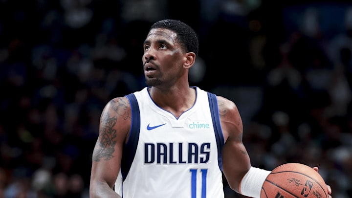 Dallas Mavericks guard Kyrie Irving controls the ball against the Charlotte Hornets.