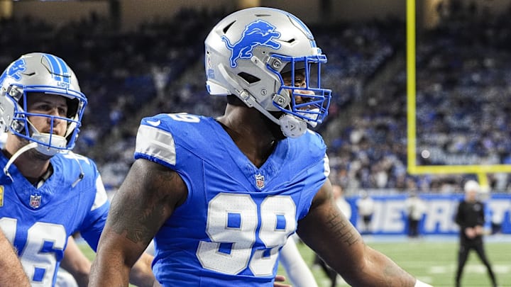 Nov 17, 2024; Detroit, MI, USA; Detroit Lions defensive end Za'Darius Smith (99) high-fives teammates at warm up before the game between Detroit Lions and Jacksonville Jaguars at Ford Field in Detroit on Sunday, Nov. 17, 2024. Mandatory Credit: Junfu Han/USA TODAY Network via Imagn Images 