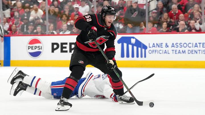 May 29, 2026; Raleigh, North Carolina, USA; Carolina Hurricanes left wing Eric Robinson (50) skates with the puck against Montreal Canadiens defenseman Mike Matheson (8) (obscured) in game five of the Eastern Conference Final of the 2026 Stanley Cup Playoffs during the first period at Lenovo Center. Mandatory Credit: James Guillory-Imagn Images