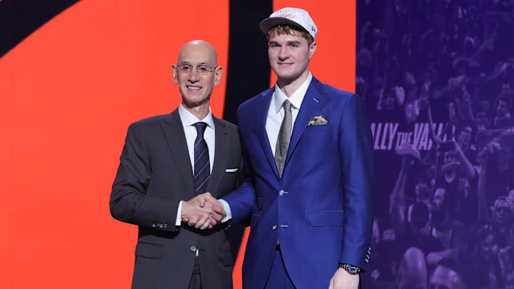 Jun 25, 2025; Brooklyn, NY, USA; Liam McNeeley stands with NBA commissioner Adam Silver after being selected as the 29th pick by the Phoenix Suns in the first round of the 2025 NBA Draft at Barclays Center. Mandatory Credit: Brad Penner-Imagn Images Jun 25, 2025; Brooklyn, NY, USA; Liam McNeeley stands with NBA commissioner Adam Silver after being selected as the 29th pick by the Phoenix Suns in the first round of the 2025 NBA Draft at Barclays Center. Mandatory Credit: Brad Penner-Imagn Images