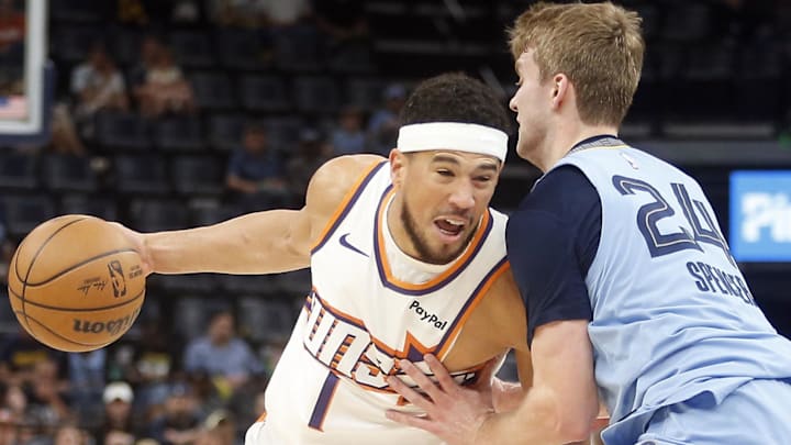 Mar 30, 2026; Memphis, Tennessee, USA; Phoenix Suns guard Devin Booker (1) drives to the basket as Memphis Grizzlies guard Cam Spencer (24) during the first quarter at FedExForum. Mandatory Credit: Petre Thomas-Imagn Images