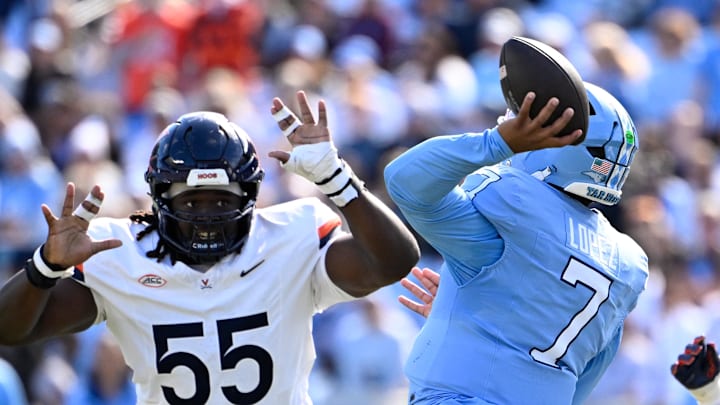 Oct 25, 2025; Chapel Hill, North Carolina, USA; North Carolina Tar Heels quarterback Gio Lopez (7) passes the ball as Virginia Cavaliers defensive tackles Anthony Britton (55) and Jason Hammond (91) pressure in the first quarter at Kenan Stadium. Mandatory Credit: Bob Donnan-Imagn Images