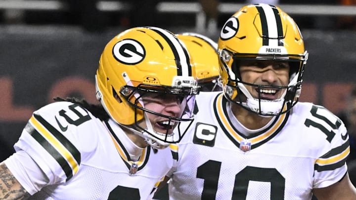 Green Bay Packers receiver Christian Watson (9) and quarterback Jordan Love react after a touchdown against the Bears.