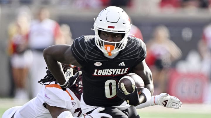 Nov 4, 2023; Louisville, Kentucky, USA;  Louisville Cardinals wide receiver Chris Bell (0) runs the ball against the Virginia Tech Hokies during the first quarter at L&N Federal Credit Union Stadium.