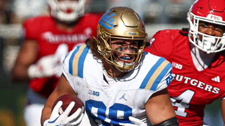 Oct 19, 2024; Piscataway, New Jersey, USA; UCLA Bruins tight end Moliki Matavao (88) gains yards after catch as Rutgers Scarlet Knights defensive back Desmond Igbinosun (4) during the second half at SHI Stadium. Mandatory Credit: Vincent Carchietta-Imagn Images Oct 19, 2024; Piscataway, New Jersey, USA; UCLA Bruins tight end Moliki Matavao (88) gains yards after catch as Rutgers Scarlet Knights defensive back Desmond Igbinosun (4) during the second half at SHI Stadium. Mandatory Credit: Vincent Carchietta-Imagn Images