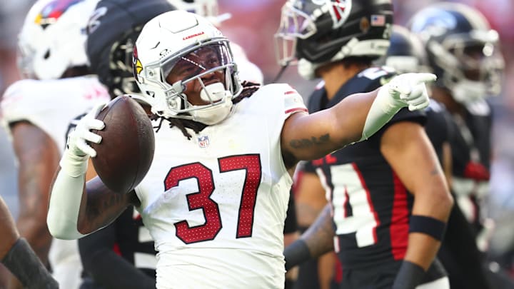 Dec 21, 2025; Glendale, Arizona, USA;  Arizona Cardinals running back Corey Kiner (37) celebrates after a carry against the Atlanta Falcons during the first half at State Farm Stadium. Mandatory Credit: Mark J. Rebilas-Imagn Images