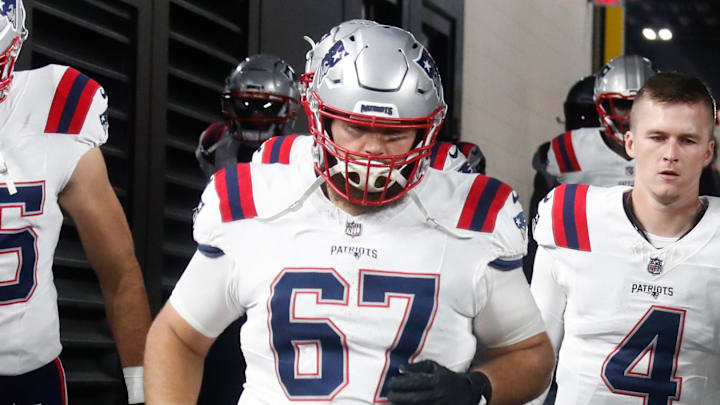 Dec 7, 2023; Pittsburgh, Pennsylvania, USA;  New England Patriots tight end Hunter Henry (85) and center Jake Andrews (67) and quarterback Bailey Zappe (4) take the field against the Pittsburgh Steelers at Acrisure Stadium. Mandatory Credit: Charles LeClaire-Imagn Images