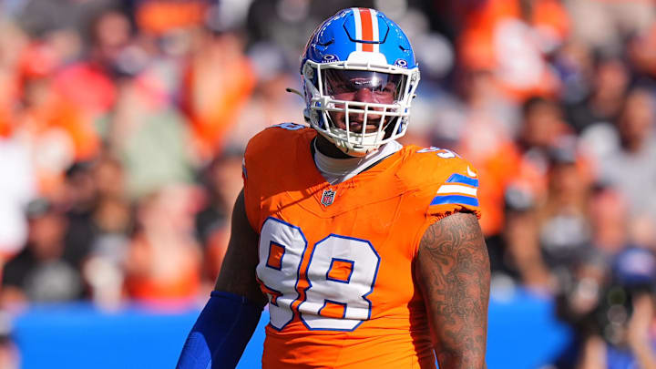 Oct 6, 2024; Denver, Colorado, USA; Denver Broncos defensive end John Franklin-Myers (98) reacts to a defensive stop in the second half against the Las Vegas Raiders at Empower Field at Mile High. Mandatory Credit: Ron Chenoy-Imagn Images