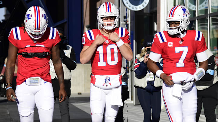 New England Patriots quarterback Joe Milton III (19) quarterback Drake Maye (10) and quarterback Jacoby Brissett (7) take the field for warmups prior to a game against the Indianapolis Colts at Gillette Stadium.