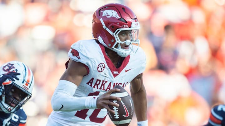 Arkansas Razorbacks quarterback Taylen Green (10) scrambles under pressure from Auburn Tigers linebacker Eugene Asante (9) as Auburn Tigers take on Arkansas Razorbacks at Jordan-Hare Stadium in Auburn, Ala., on Saturday, Sept. 21, 2024. Arkansas Razorbacks defeated Auburn Tigers 24-14.