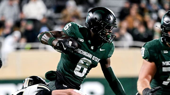 Michigan State's Nick Marsh, center, runs for a gain against Purdue during the first quarter on Friday, Nov. 22, 2024, at Spartan Stadium in East Lansing.
