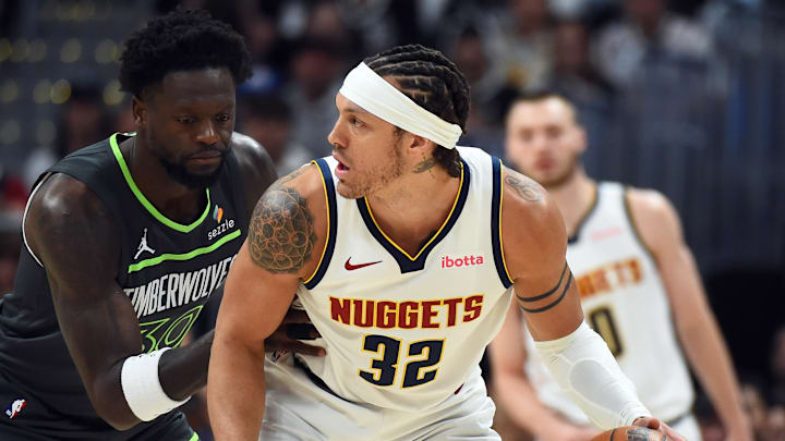 Apr 18, 2026; Denver, Colorado, USA; Denver Nuggets forward Aaron Gordon (32) handles the ball against Minnesota Timberwolves forward Julius Randle (30) during the first half in game one of the first round of the 2026 NBA Playoffs at Ball Arena.