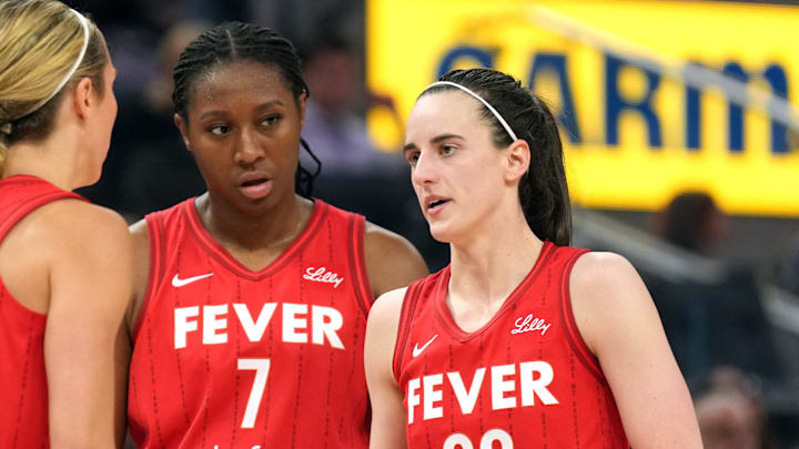 Jun 19, 2025; San Francisco, California, USA; Indiana Fever guard Caitlin Clark (22) talks to guard Lexie Hull (left) and forward Aliyah Boston (7) during the third quarter against the Golden State Valkyries at Chase Center. Mandatory Credit: Darren Yamashita-Imagn Images